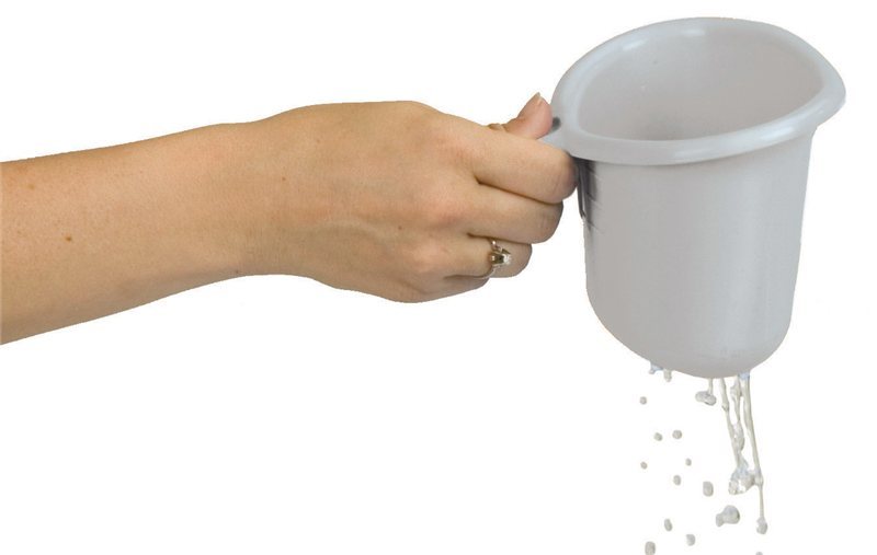 Hand holding a white plastic cup with water spilling out on a white background