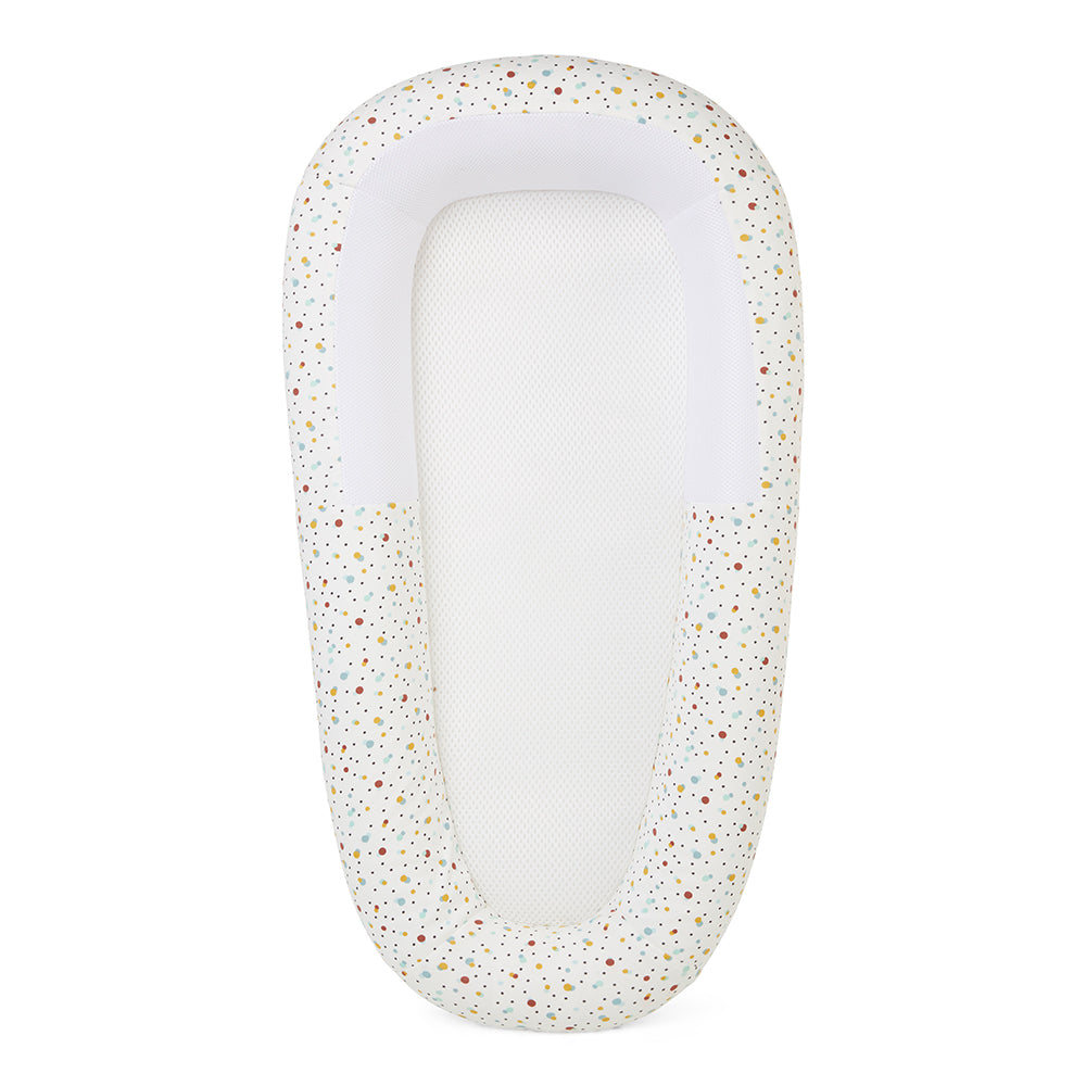 baby bed with speckled pattern on a white background