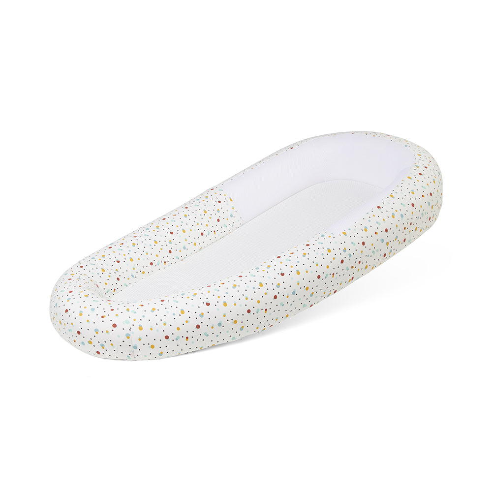 White baby bed with speckled pattern on a white background
