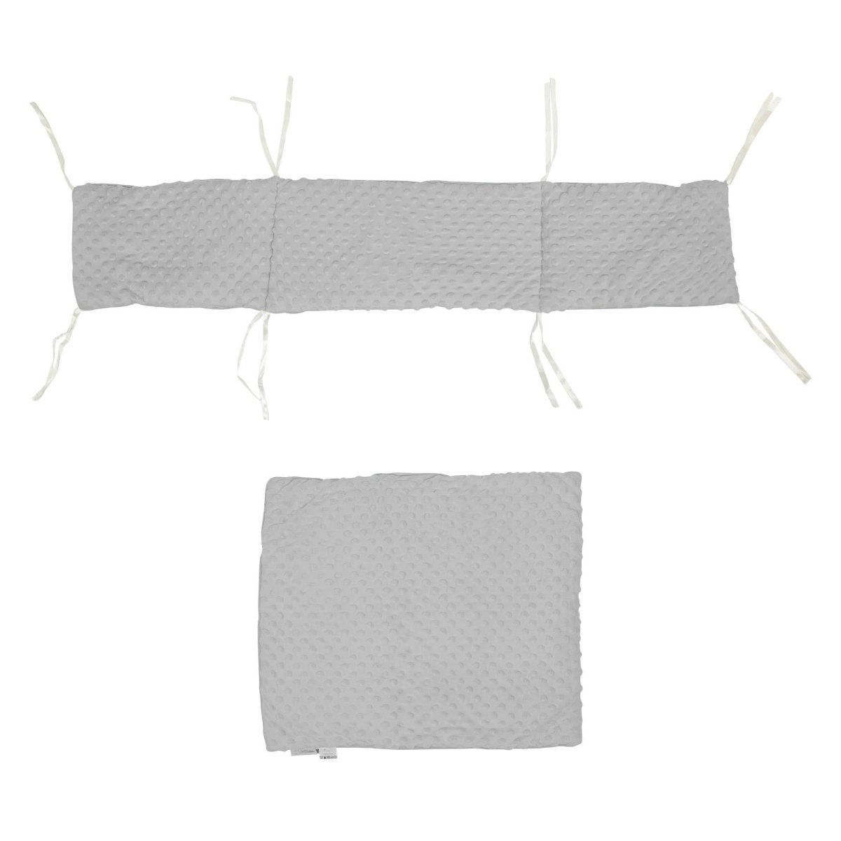 Gray quilted cover with white strings on a white background