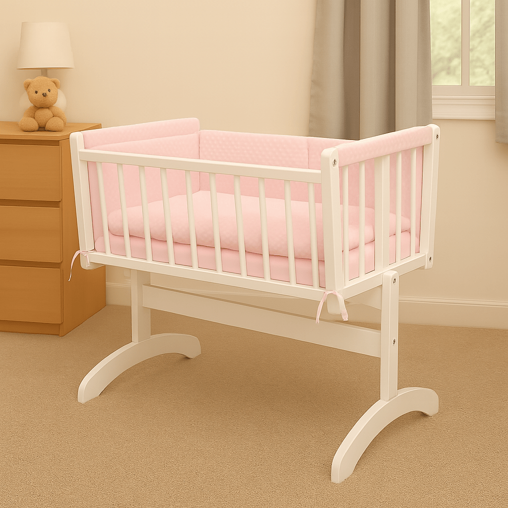 White crib with pink bedding in a nursery setting
