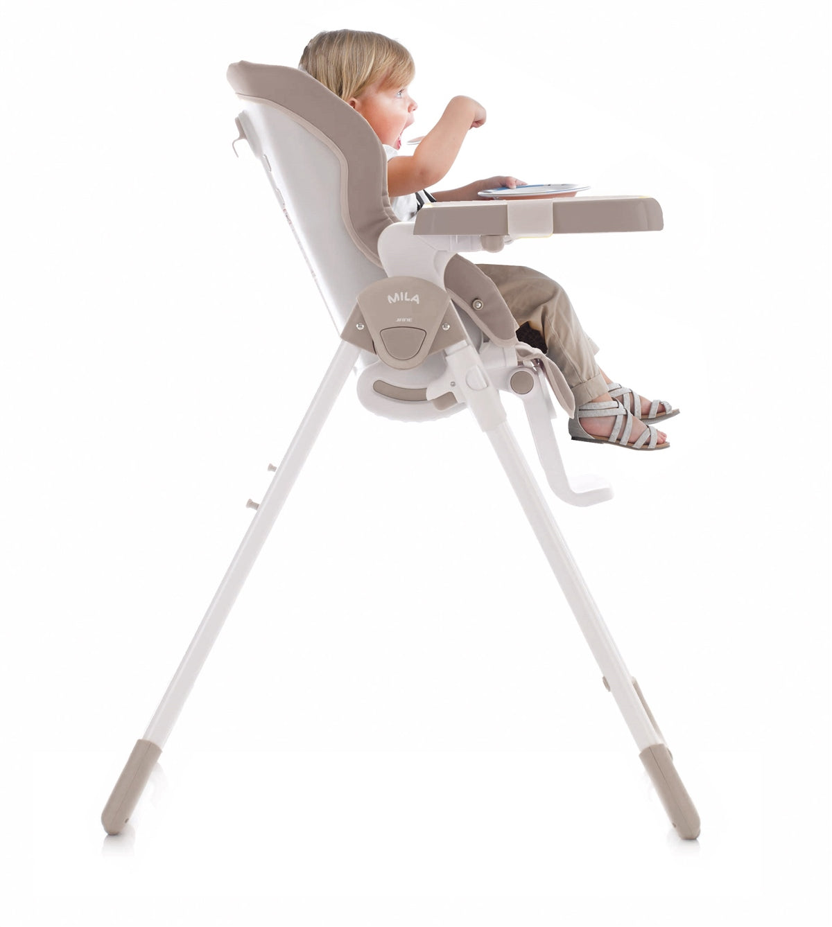 Child sitting in a high chair with a white background