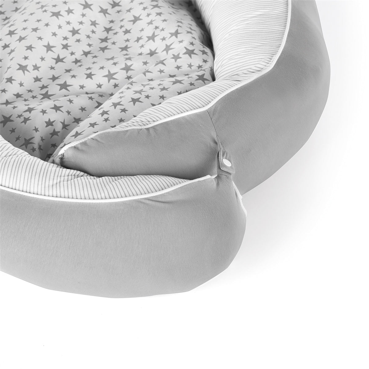 Round baby crib with star-patterned mattress on a white background