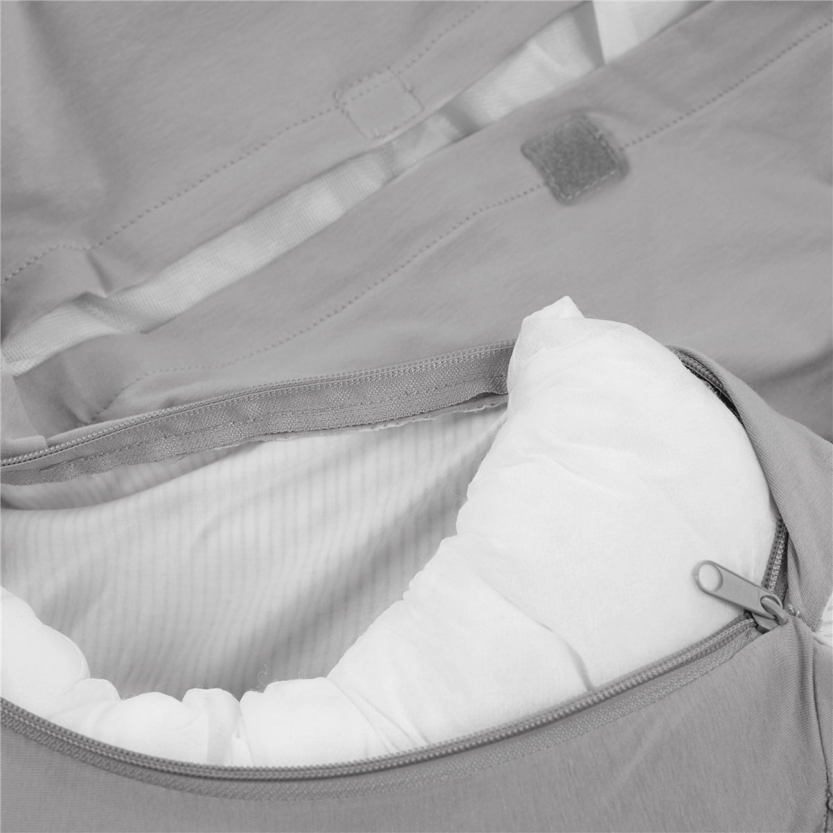 Gray bed with a white quilted lining and zipper