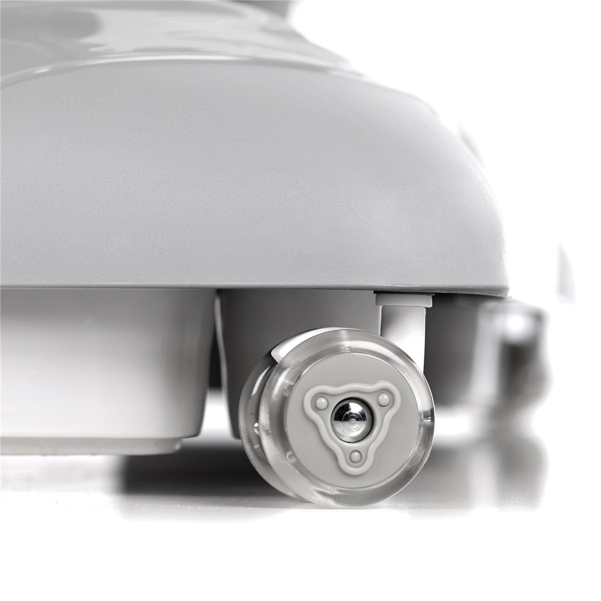 Close-up of a white wheel with metallic hub on a light gray background