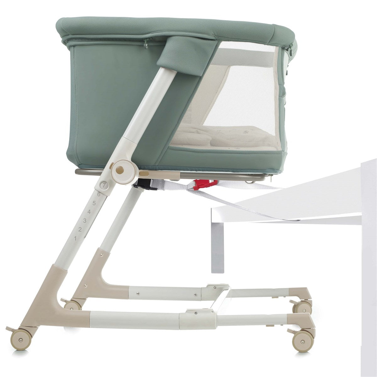 Portable baby crib with green cover on a white background