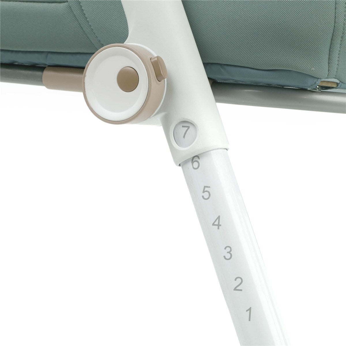 Close-up of a baby bouncer with a white frame and green cushion, showing measurement markings.