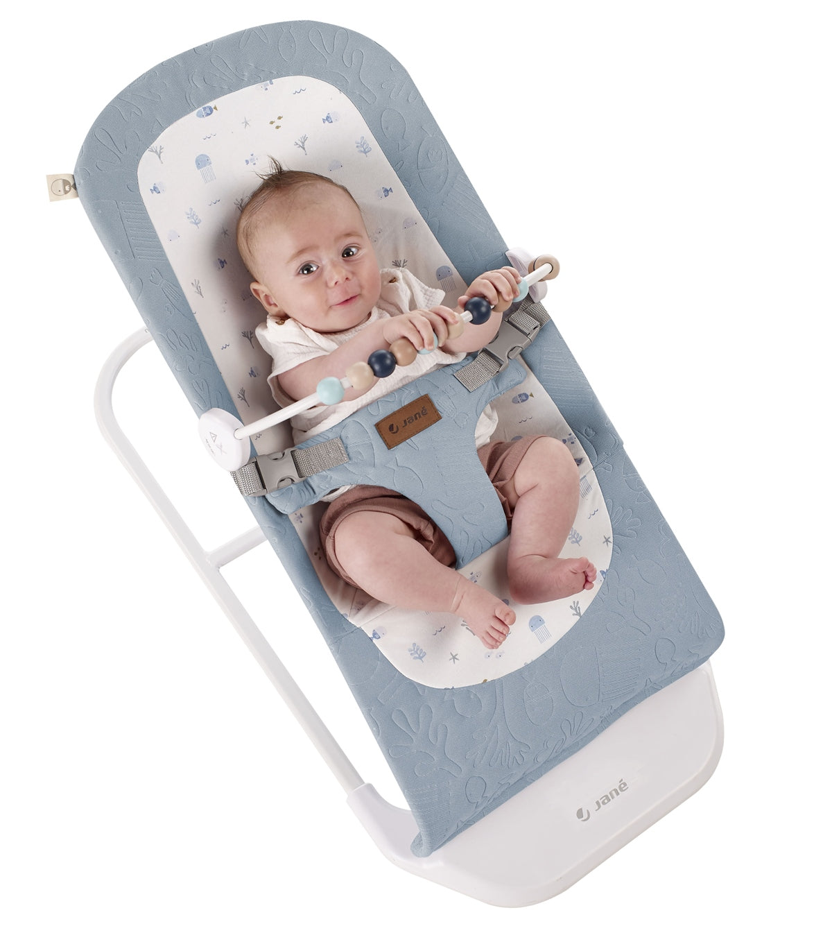 Baby in a blue and white baby bouncer with a white background