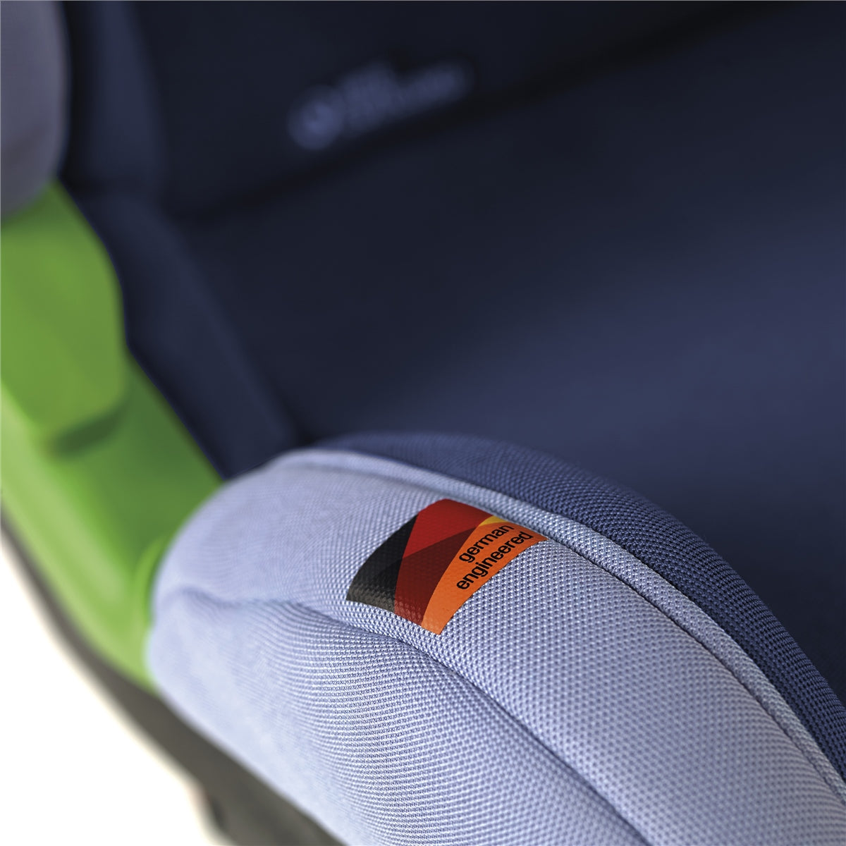 Close-up of a car seat with a visible brand logo on a blurred background