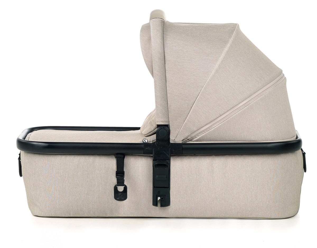 Beige baby bassinet with black straps on a white background