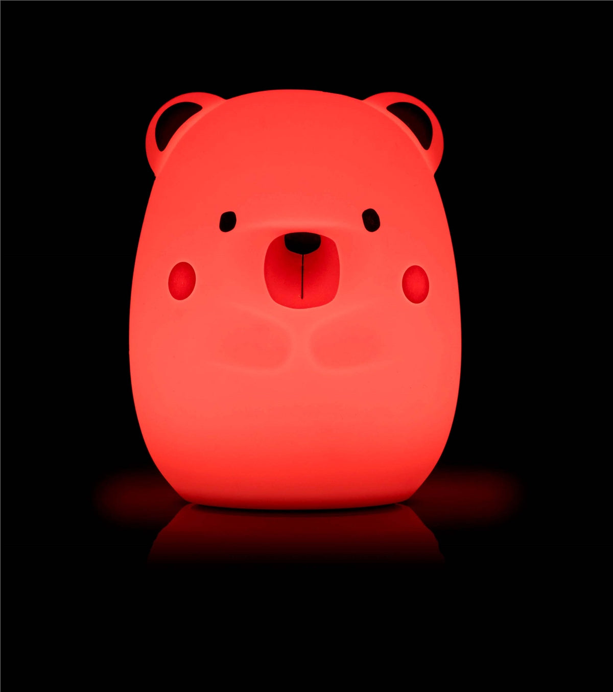 Red bear-shaped night light on a black background