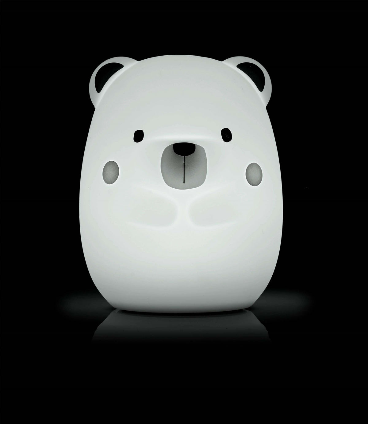 White bear-shaped night light on a black background