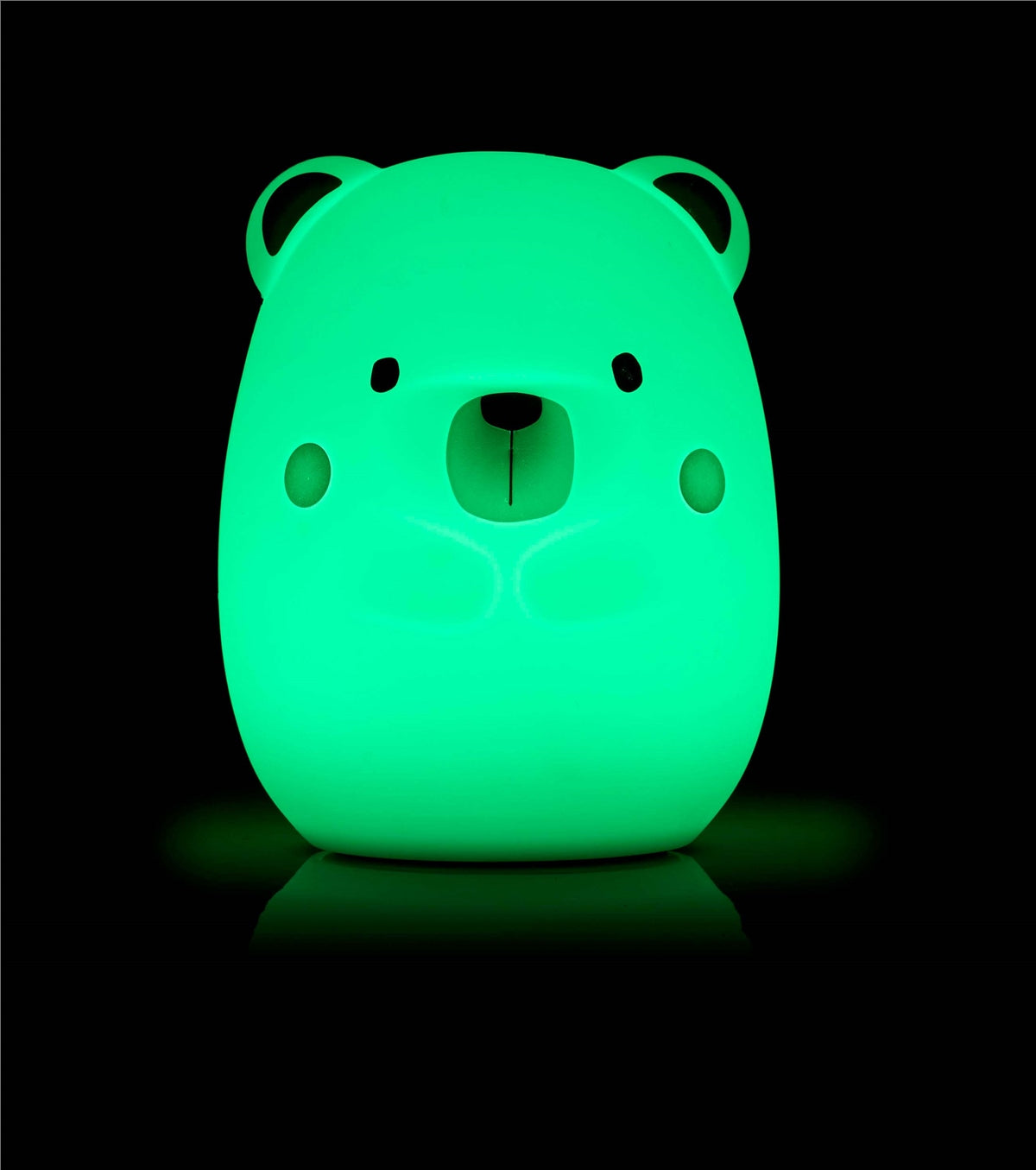 Glowing green bear-shaped night light on a black background