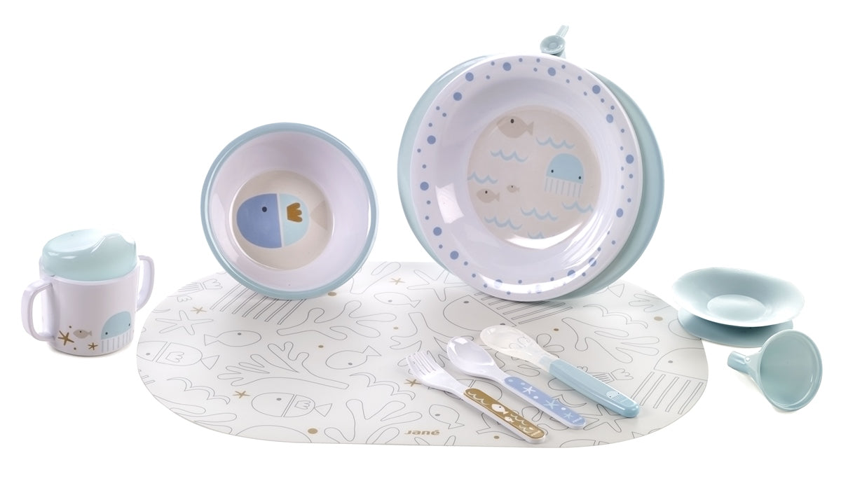 Baby dinner set with bowls, cup, and placemat on a white background