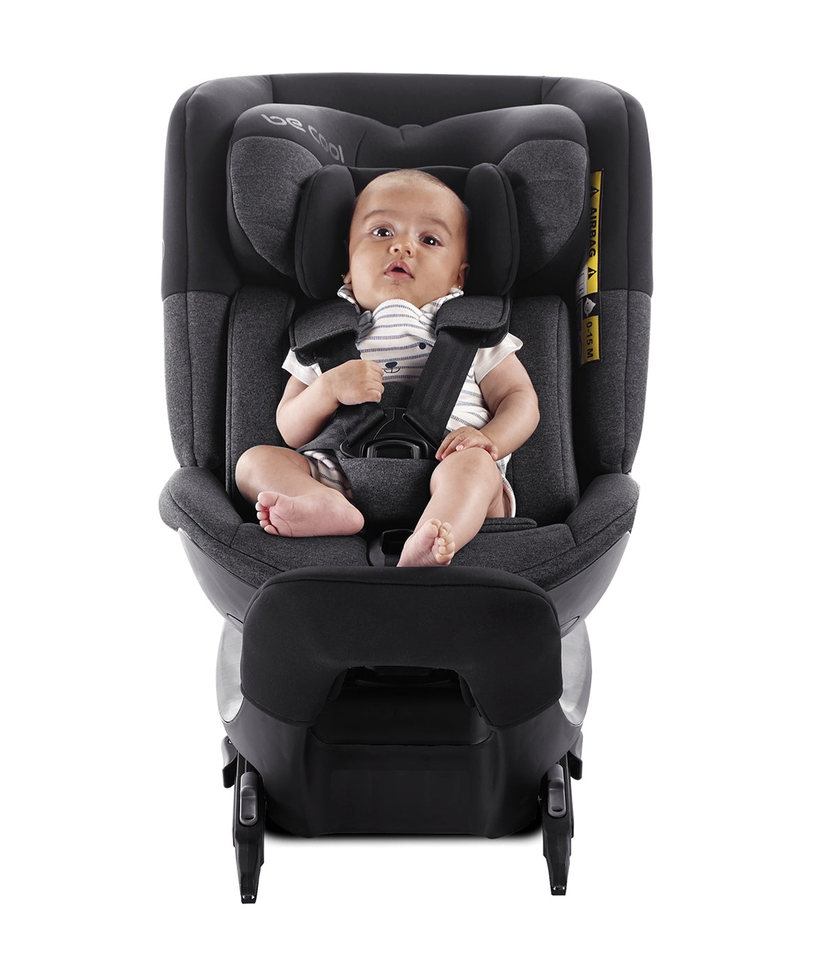 Baby sitting in a black car seat on a white background