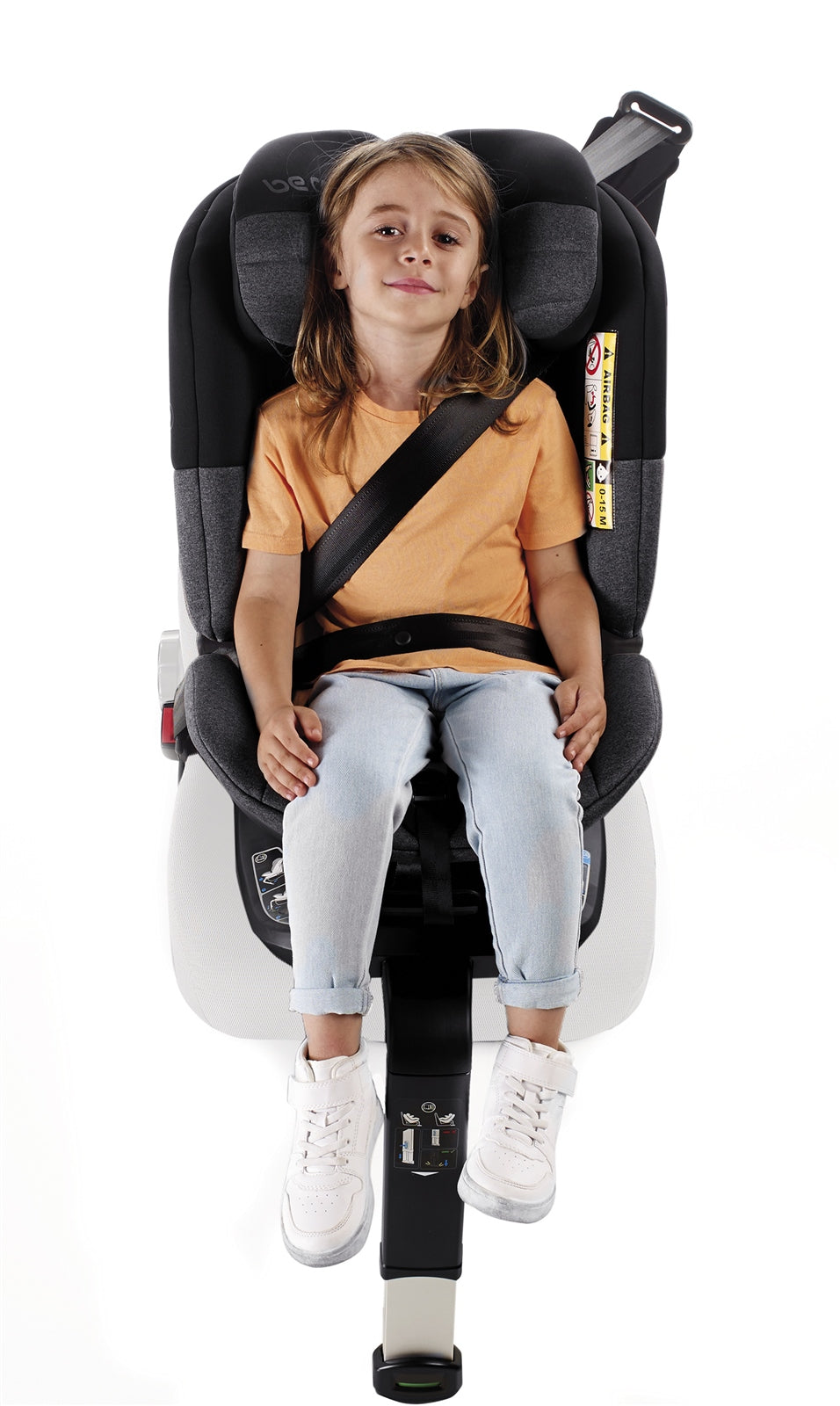 Child sitting in a black and gray car seat on a white background