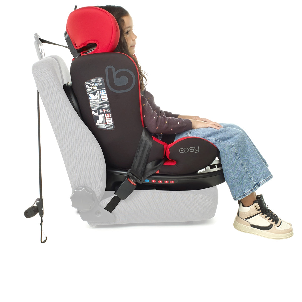 Child in a booster seat with red headrest on a white background