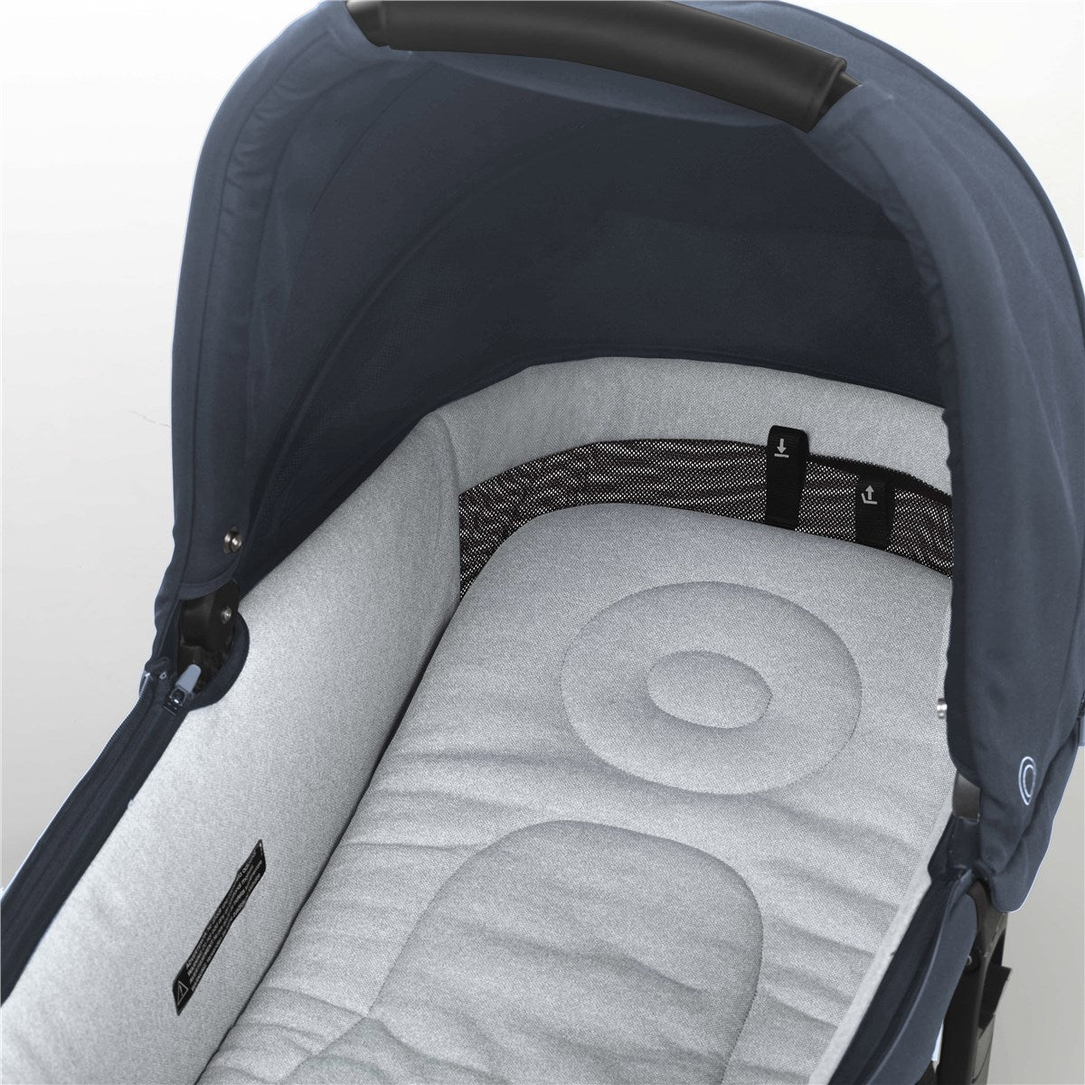 Close-up of a baby stroller with a grey cushion and black handle on a light background
