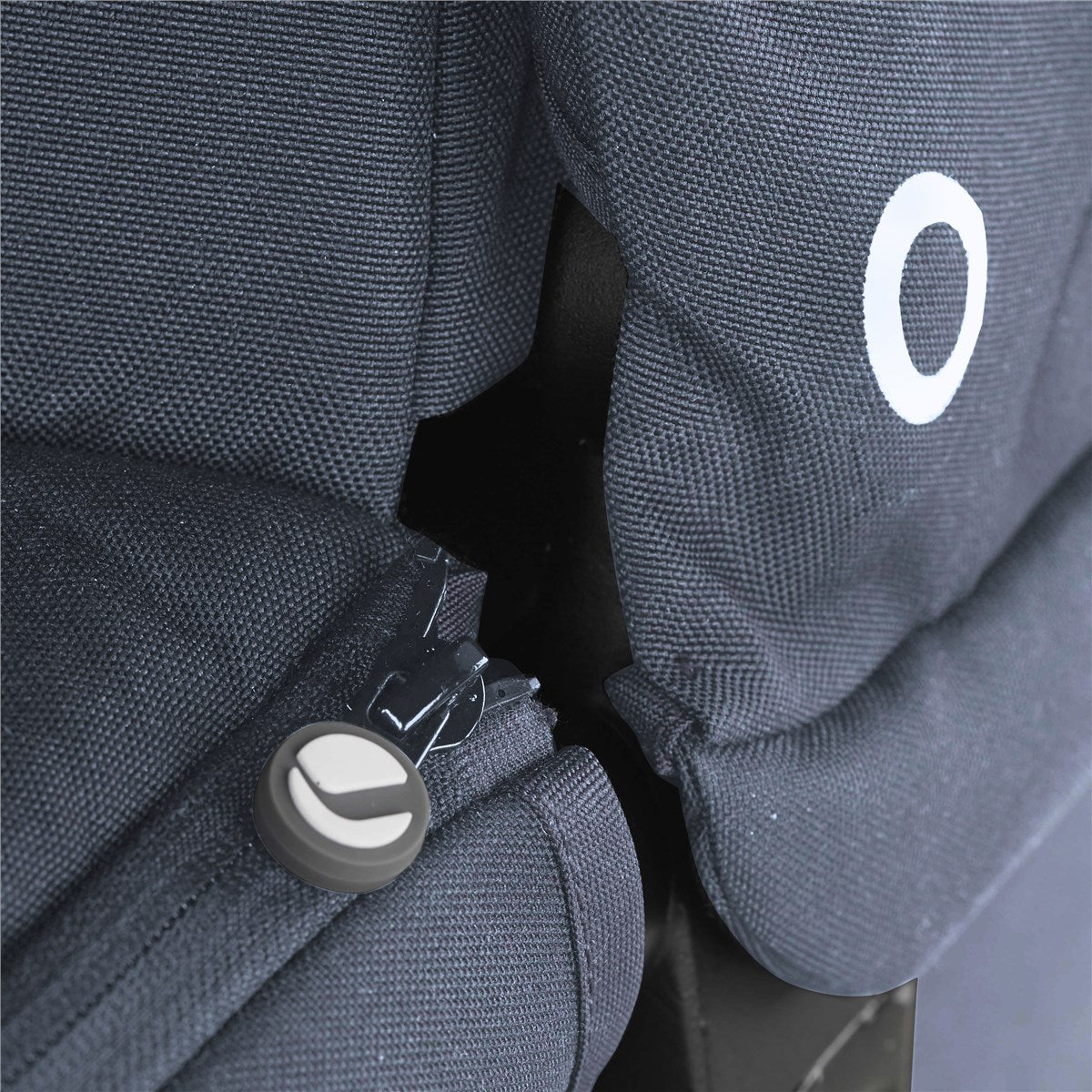 Close-up of a blue fabric with a zipper and a white logo on a black background