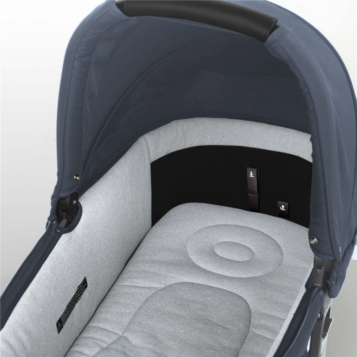 Close-up of a baby stroller with a dark blue canopy and gray seat on a light background