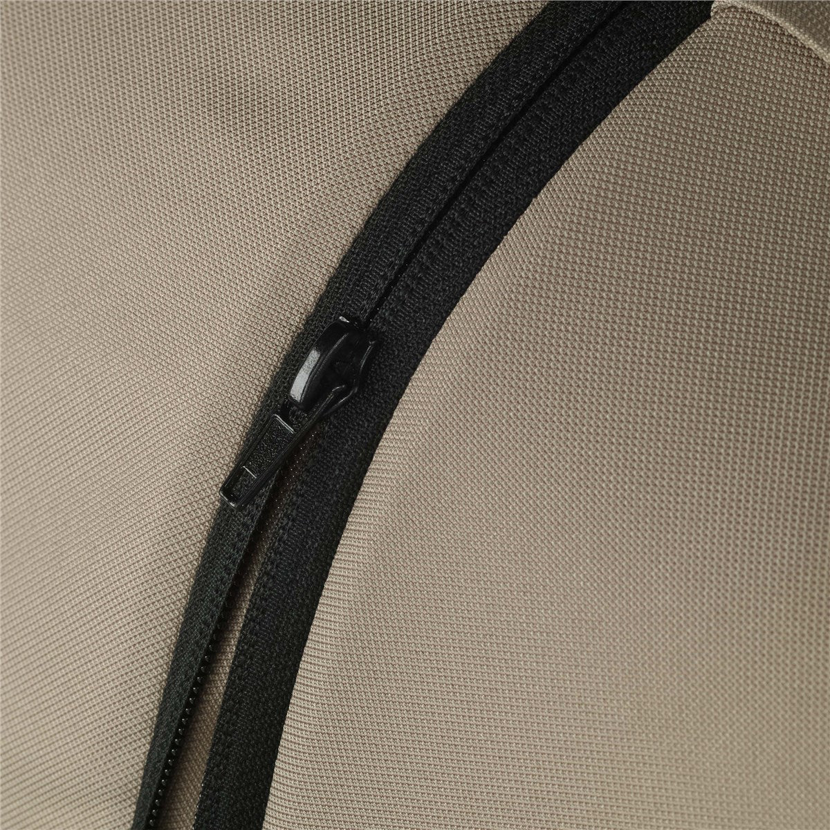 Close-up of a black zipper on beige fabric