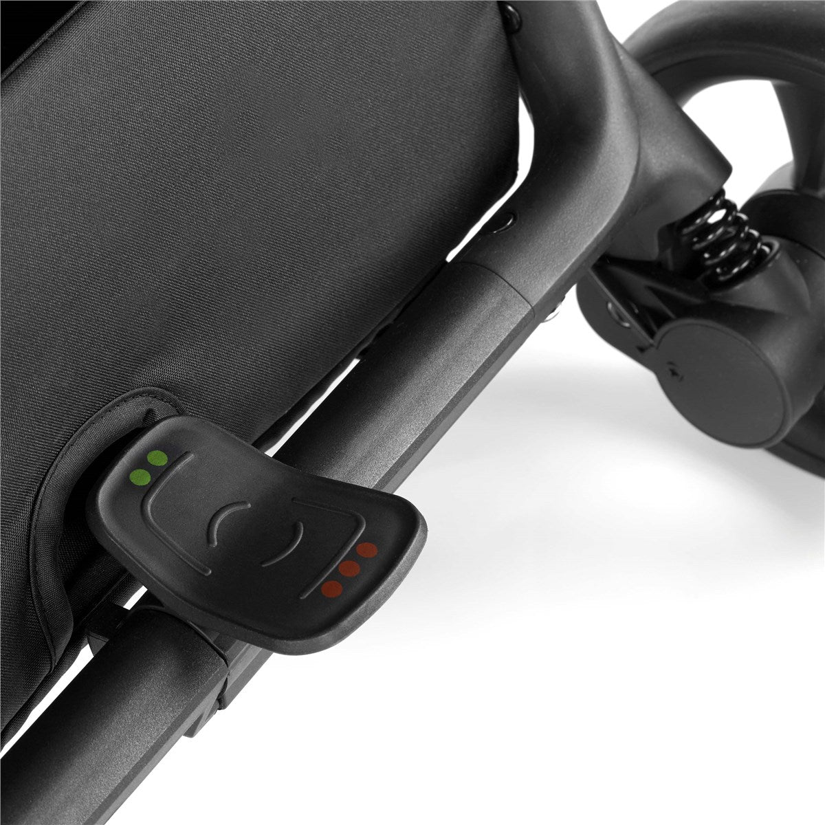 Close-up of a stroller handle with a control device attached on a white background