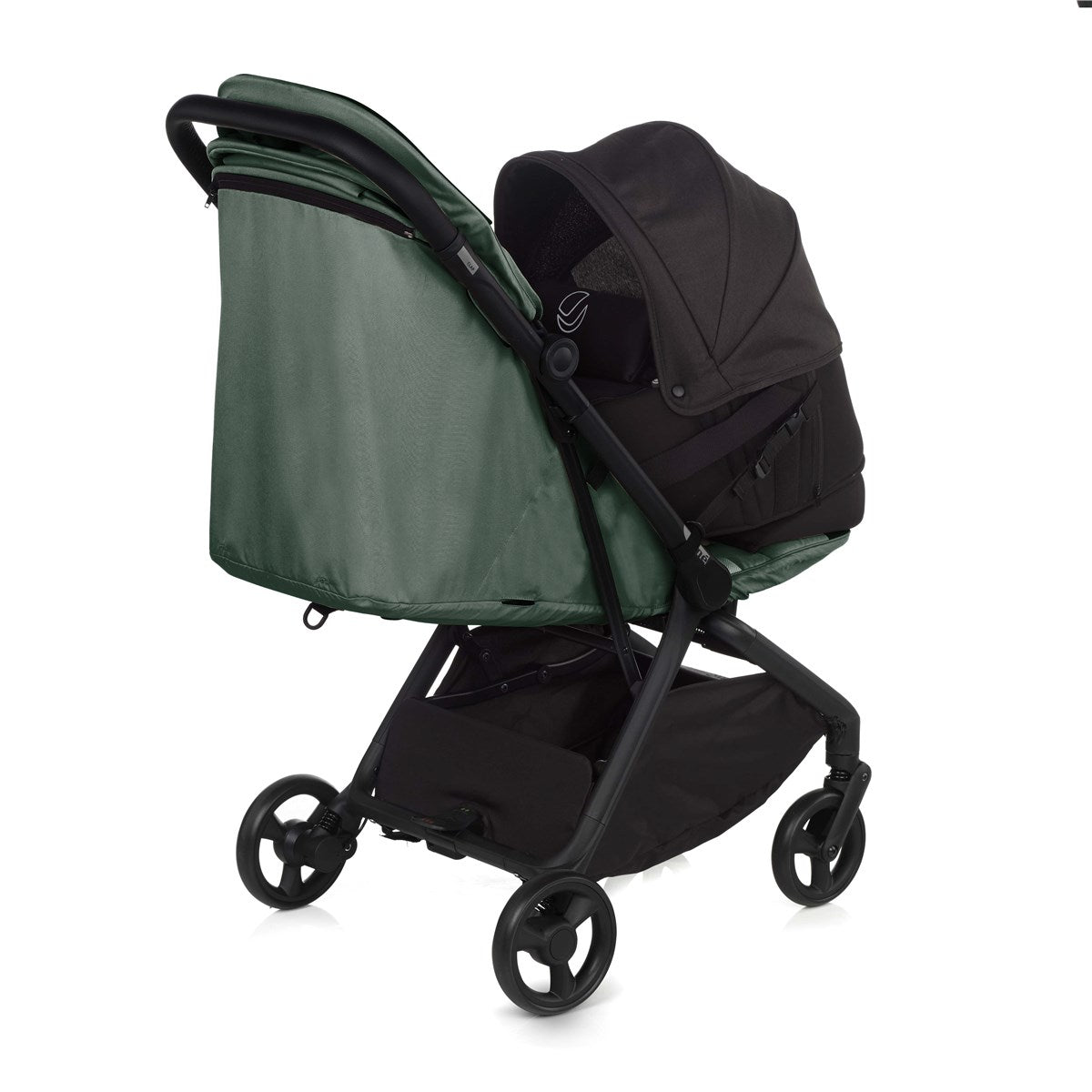 Green and black baby stroller on a white background
