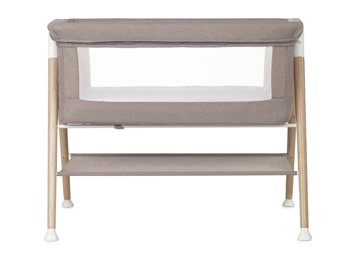 Portable crib with beige fabric cover and wooden frame on a white background