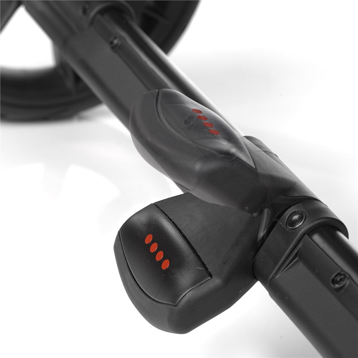 Close-up of a black stroller handle on white background 