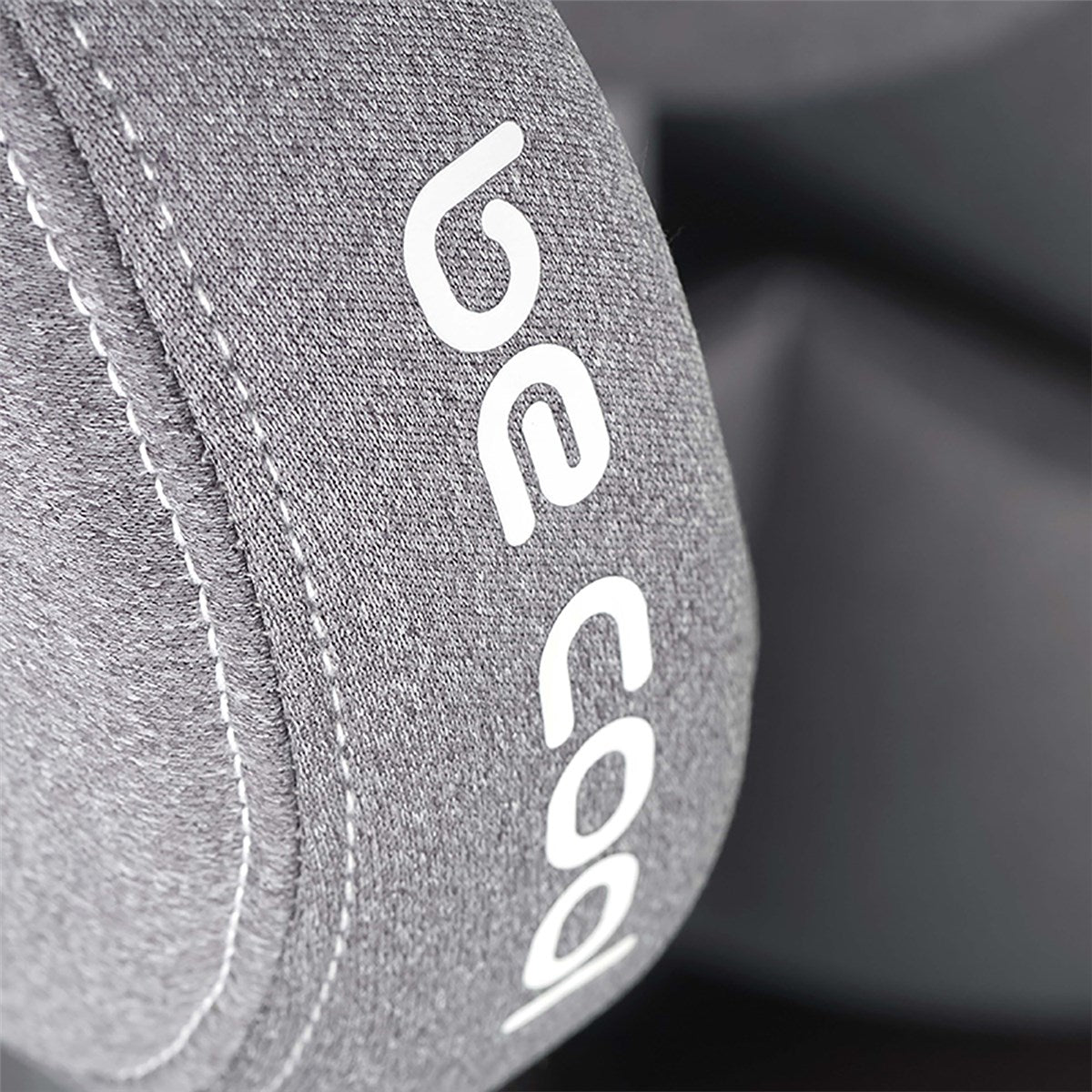 Gray fabric with white stitching and 'be code' branding on a dark background