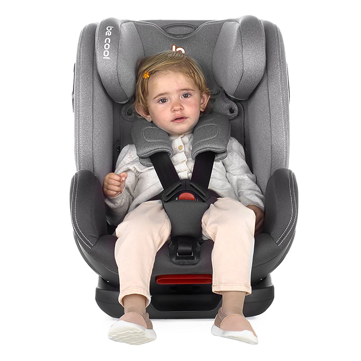 Child in a gray car seat with a white background