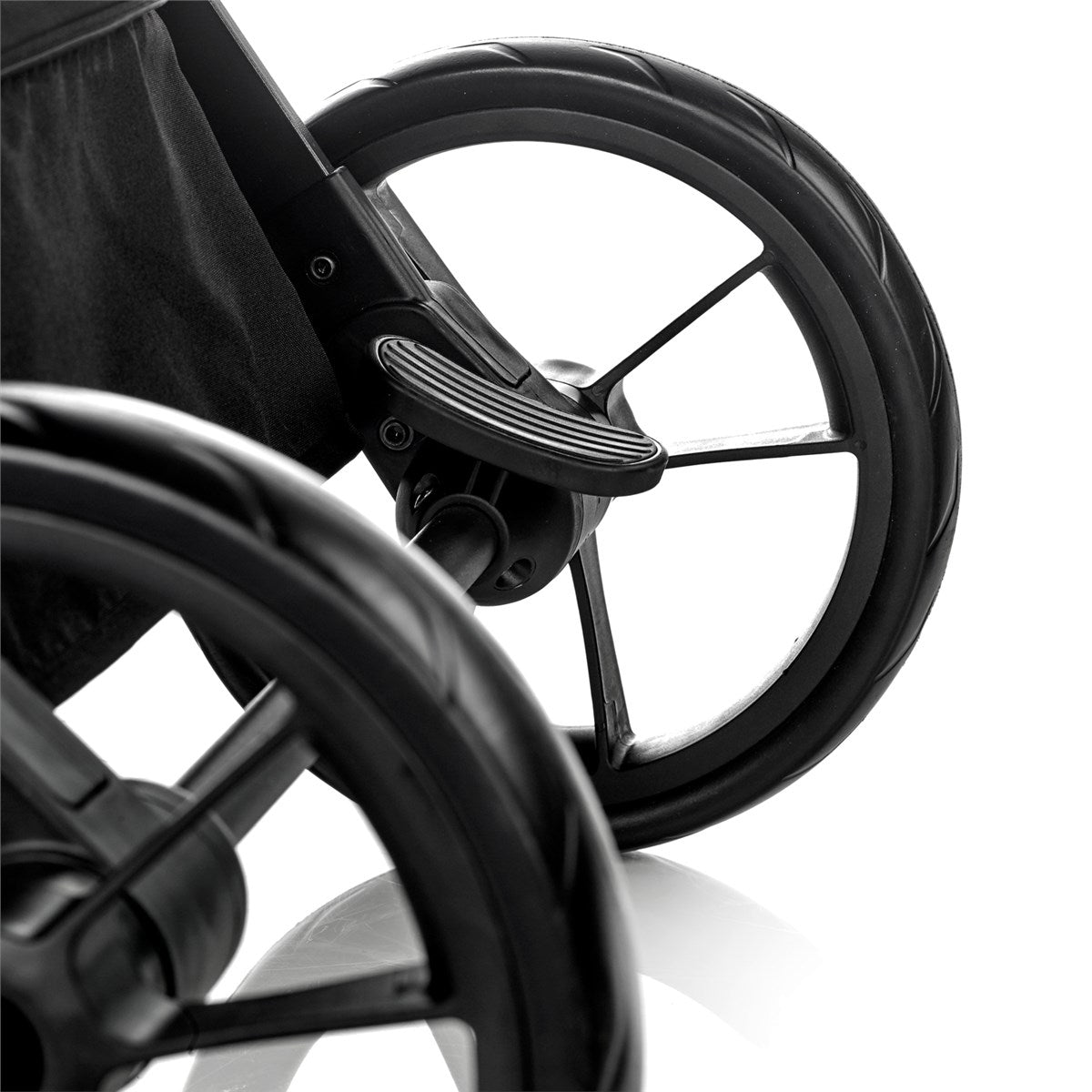 Close-up of a wheelchair with black wheels on a white background