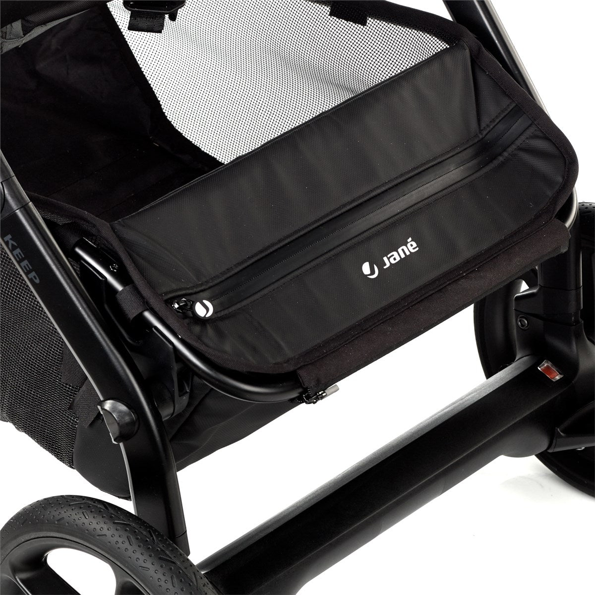 Close-up of a black stroller seat with Jané branding on a white background