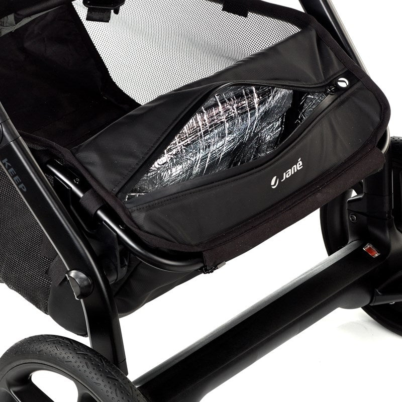 Black stroller with a storage bag featuring the Jané brand on a white background