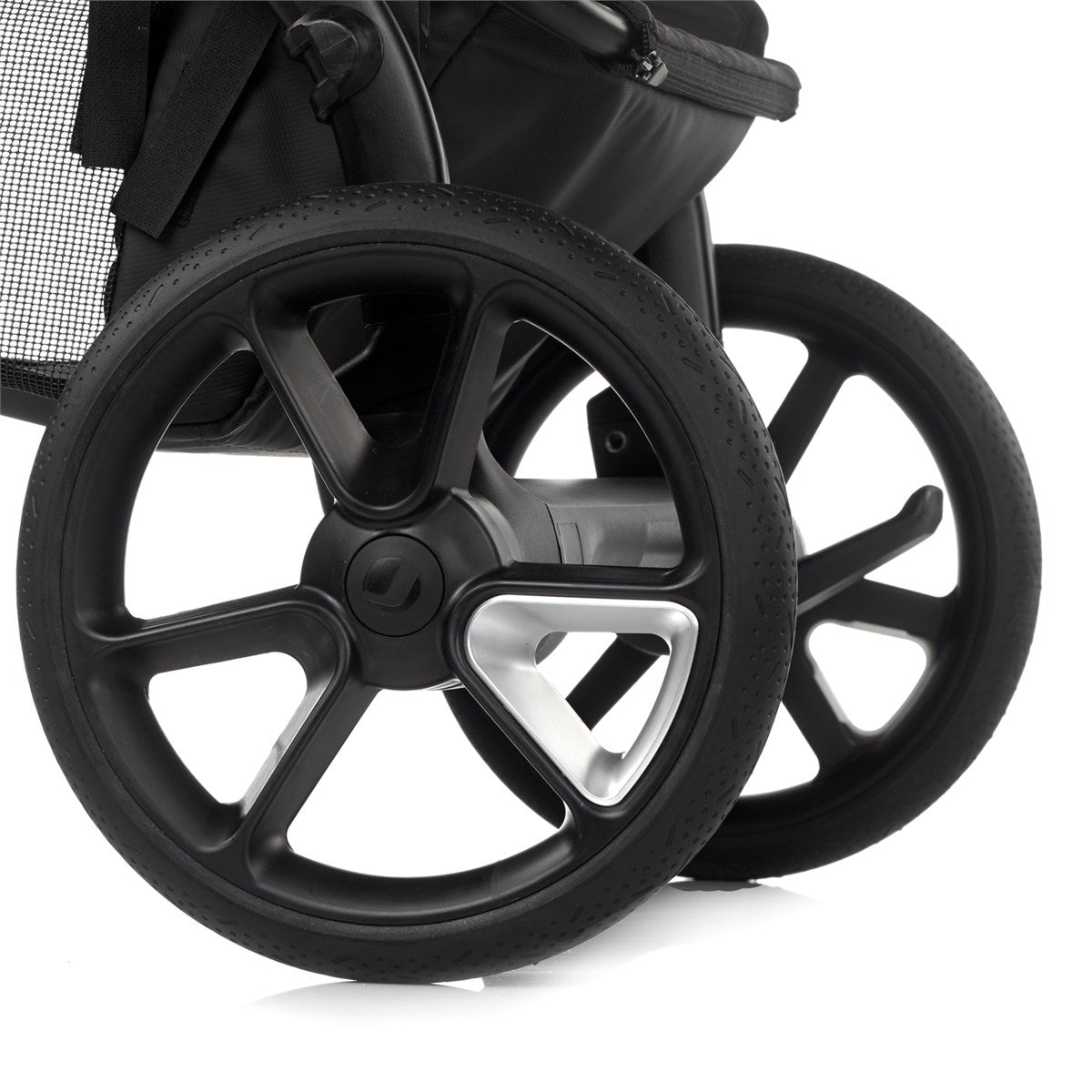 Close-up of a black stroller wheel on a white background