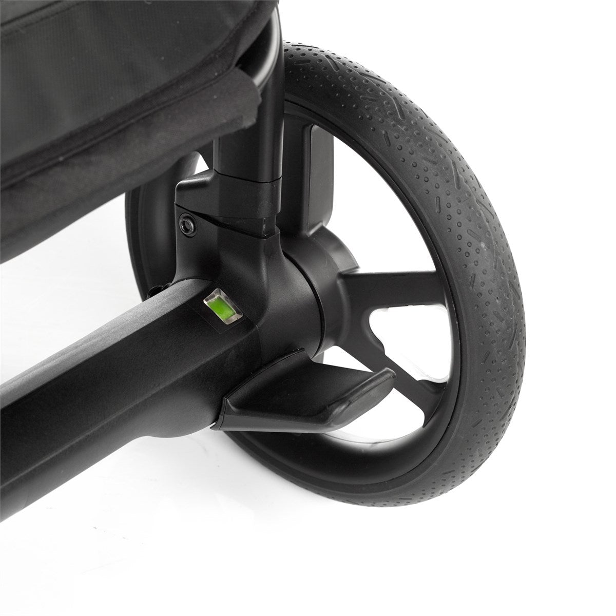 Close-up of a stroller wheel and suspension mechanism on a white background