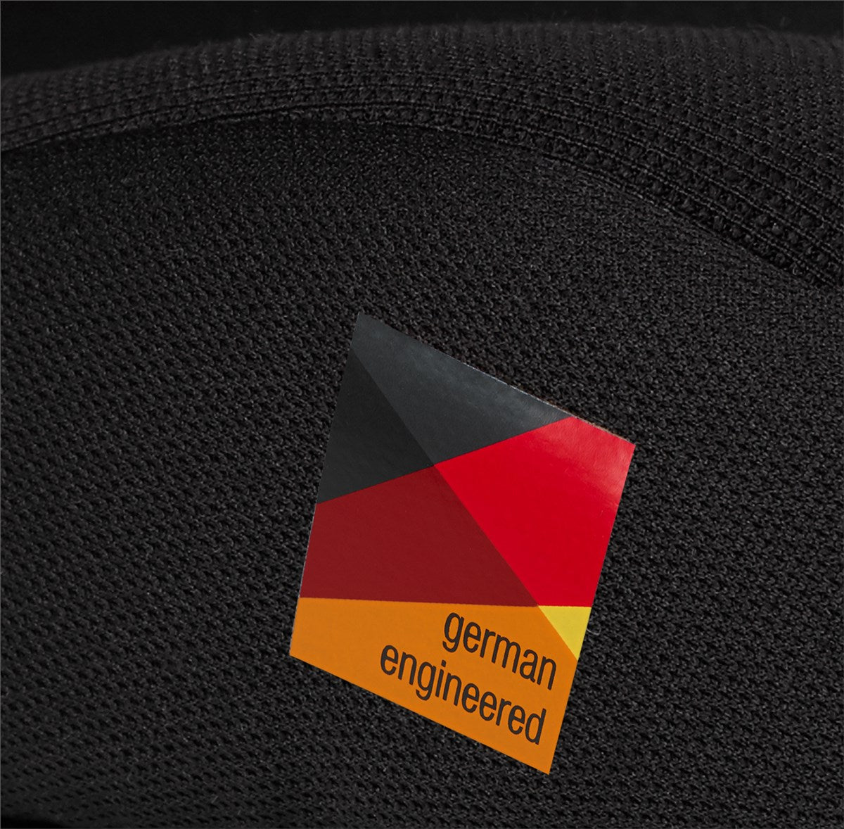 Black textured surface with a geometric 'german engineered' label