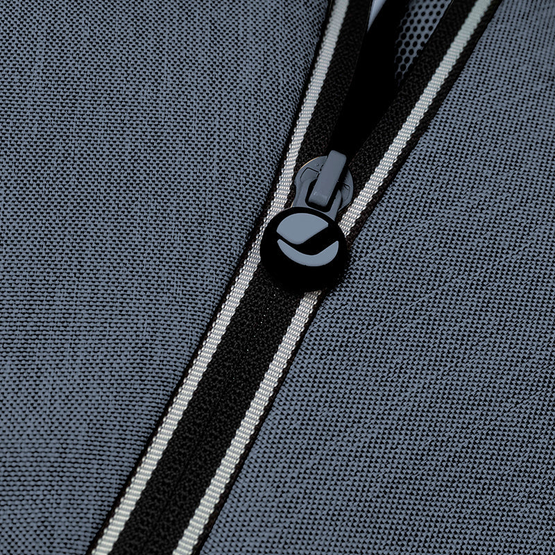 Close-up of a zipper on a textured gray fabric surface