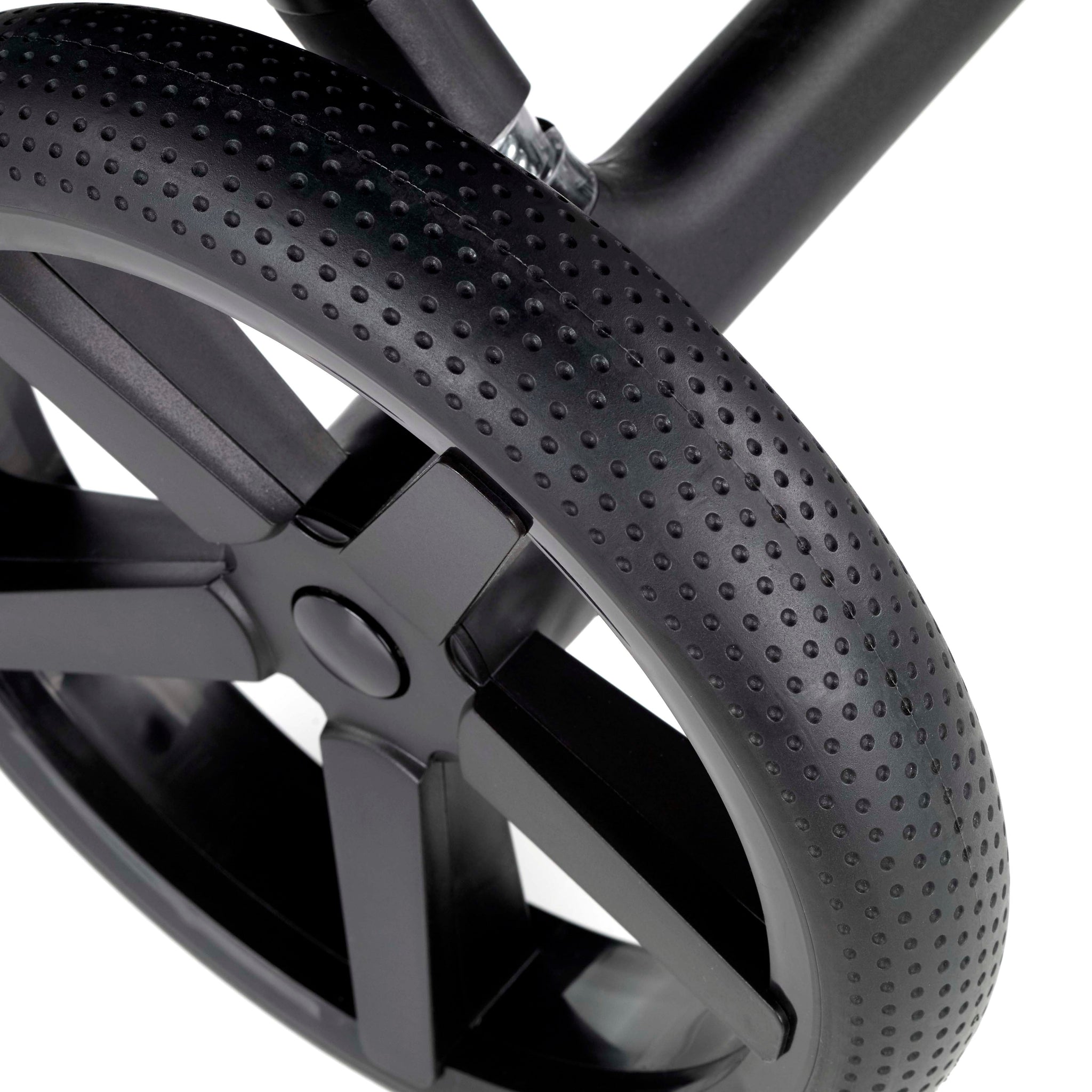 Close-up of a black stroller wheel with tread pattern on a white background