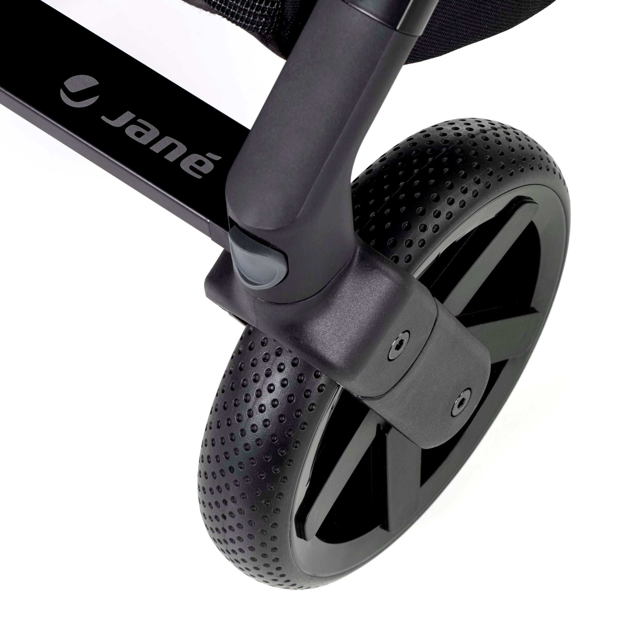 Close-up of a black stroller wheel with 'jané' branding on a white background