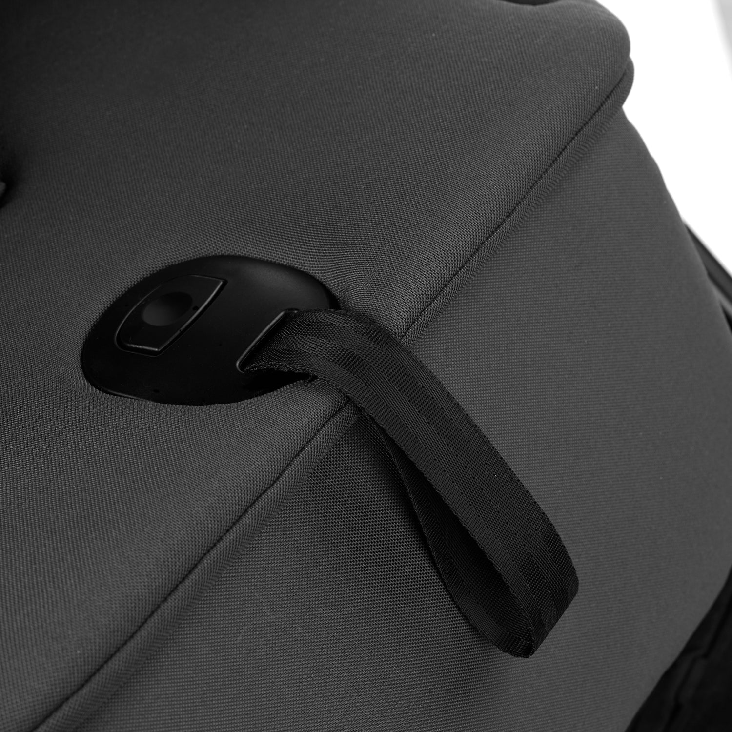 Close-up of a gray carrycot with a black strap on a white background