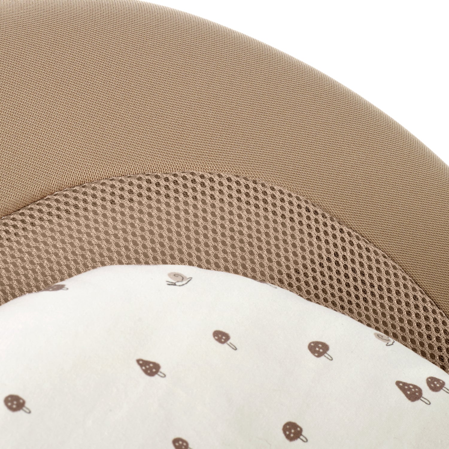 Close-up of a brown mesh baby bouncer with a white pillow featuring brown patterns on a white background.