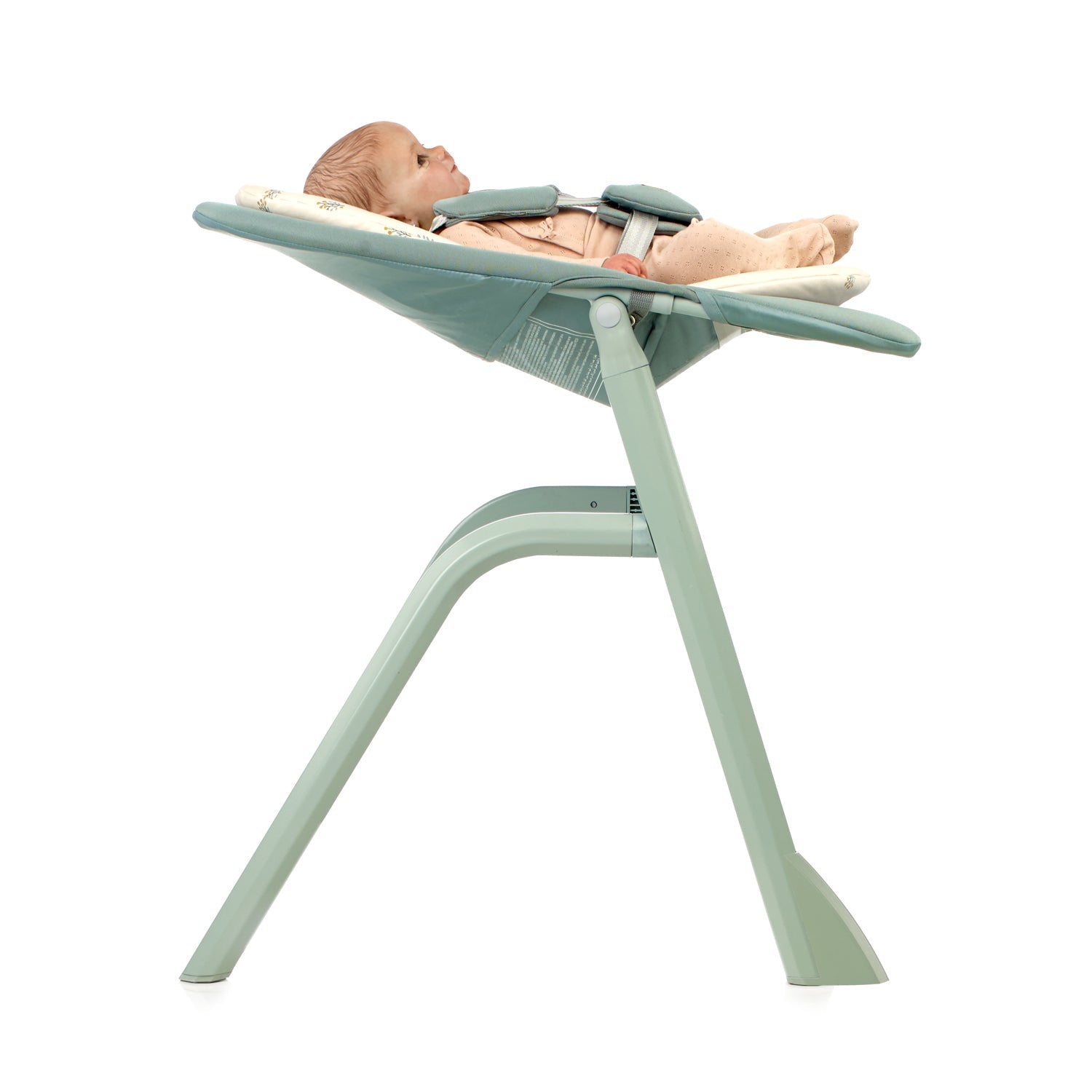 Baby in a green baby bouncer on a white background