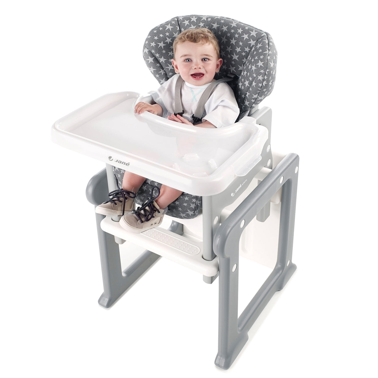 Child in a high chair with a gray and white patterned seat cover on a white background