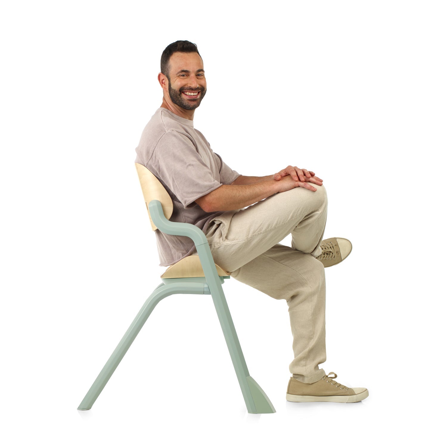 Man sitting on a modern chair with a white background