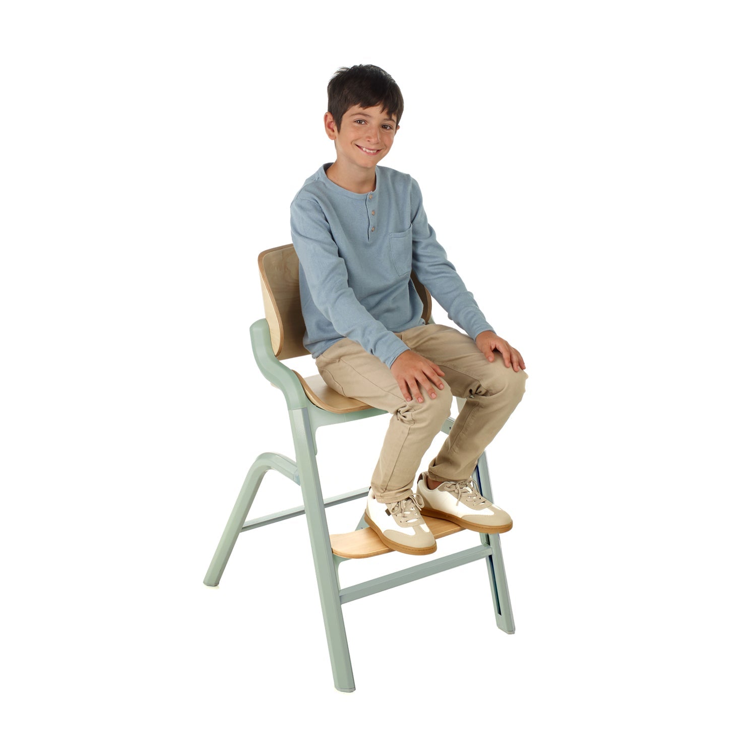 Child sitting on a height-increasing chair with a white background