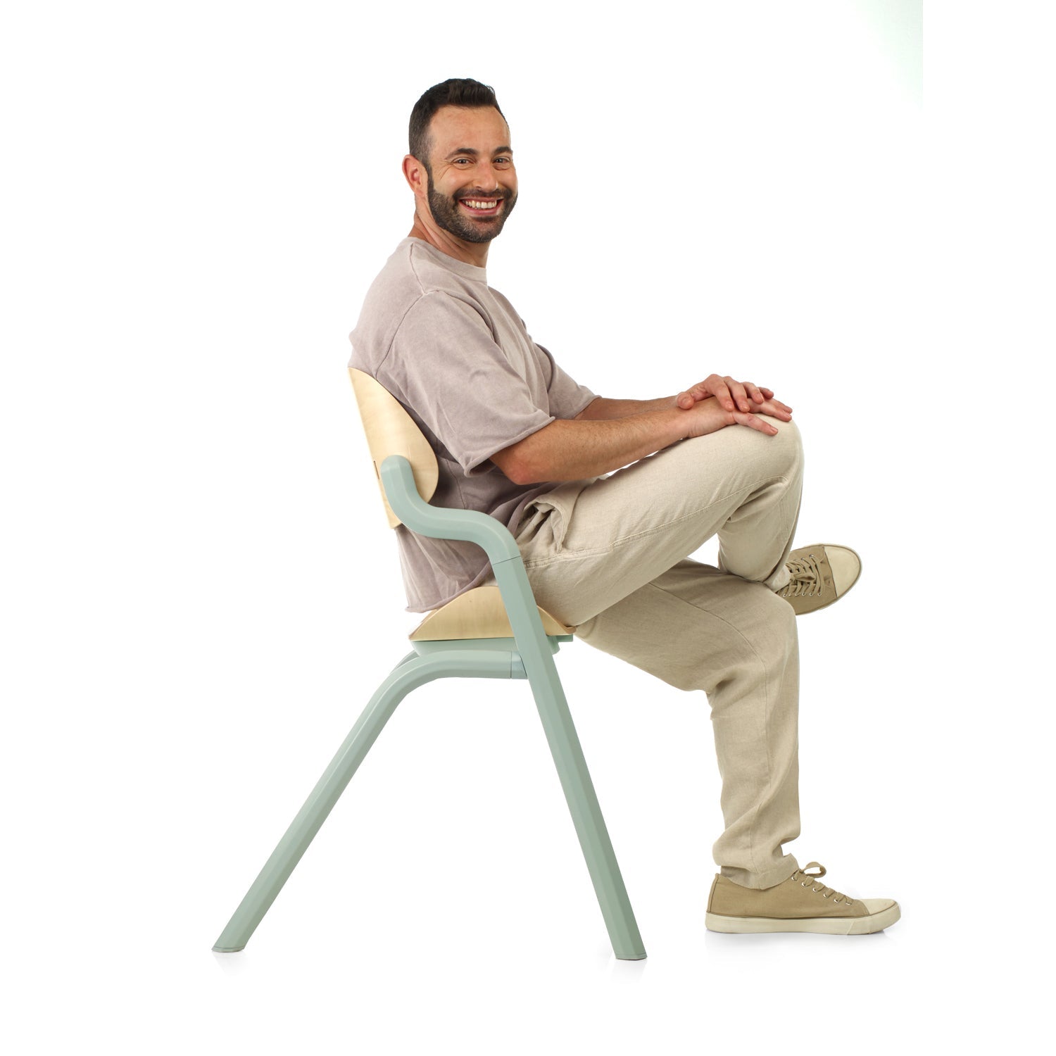 Man sitting on a modern chair with a white background