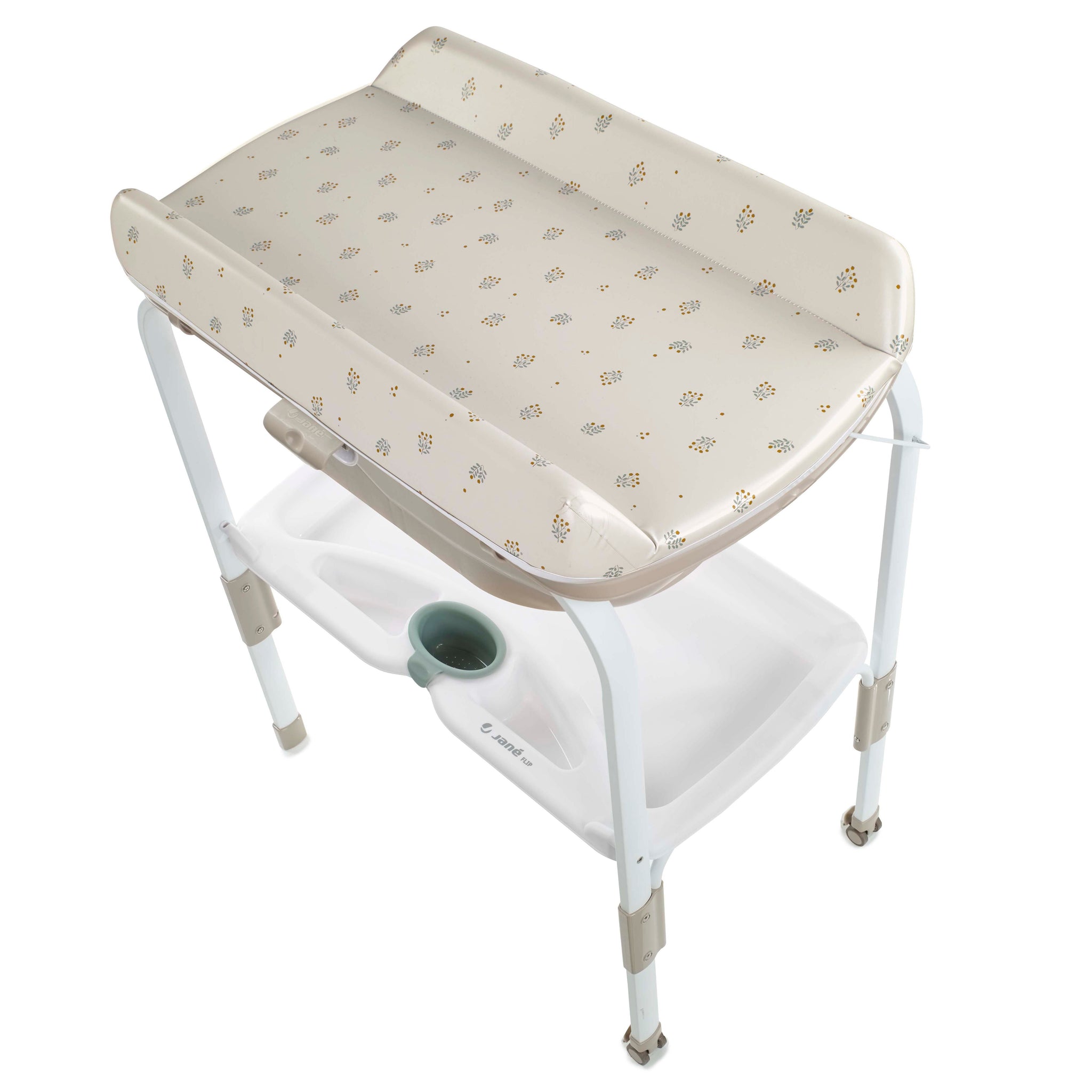 Baby changing table with floral patterned cover on a white background