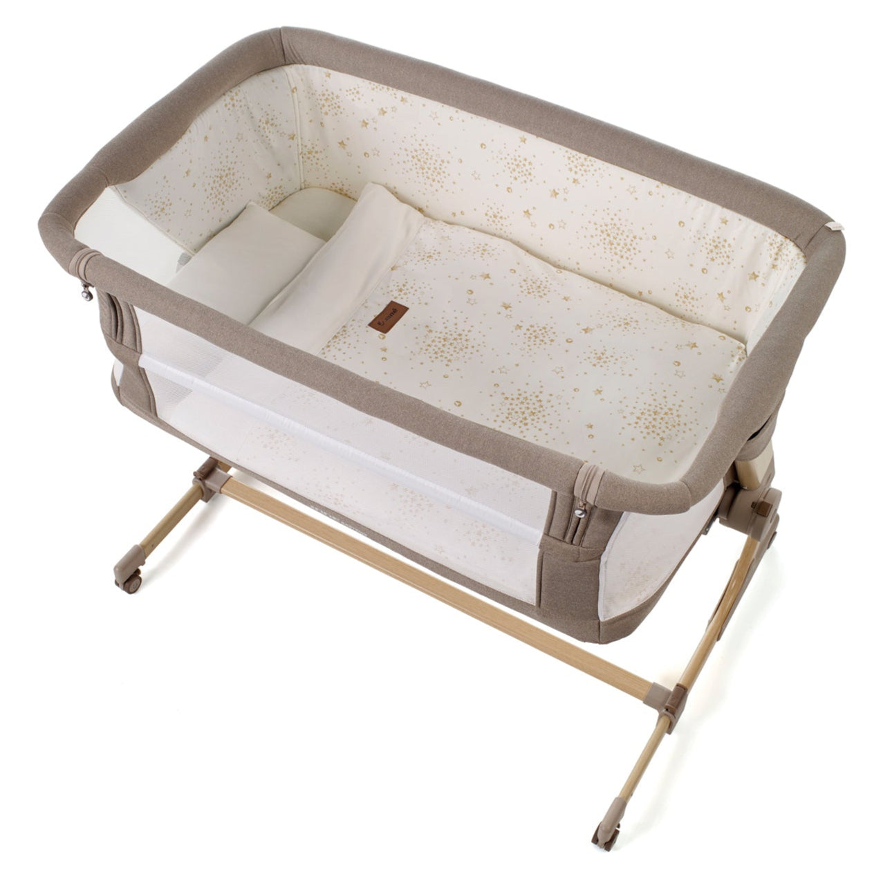 Portable baby crib with beige and white design on a white background