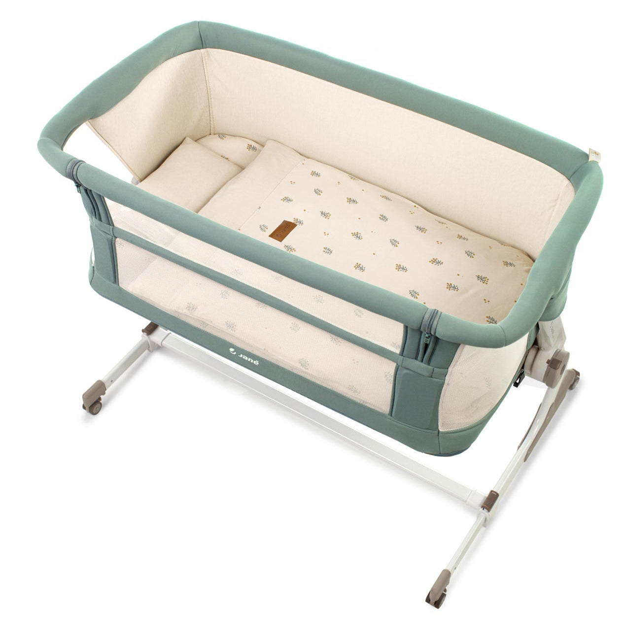 Portable baby crib with green frame and beige mattress on a white background
